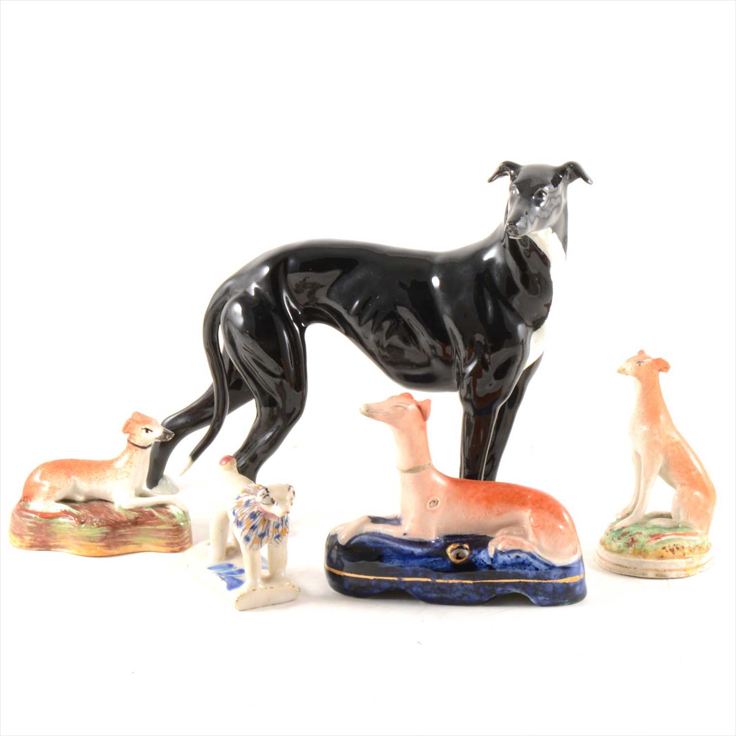 Lot 57 - A Staffordshire pen stand, designed with a recumbent greyhound, ...
