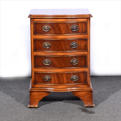 Lot 585 - A reproduction mahogany serpentine chest