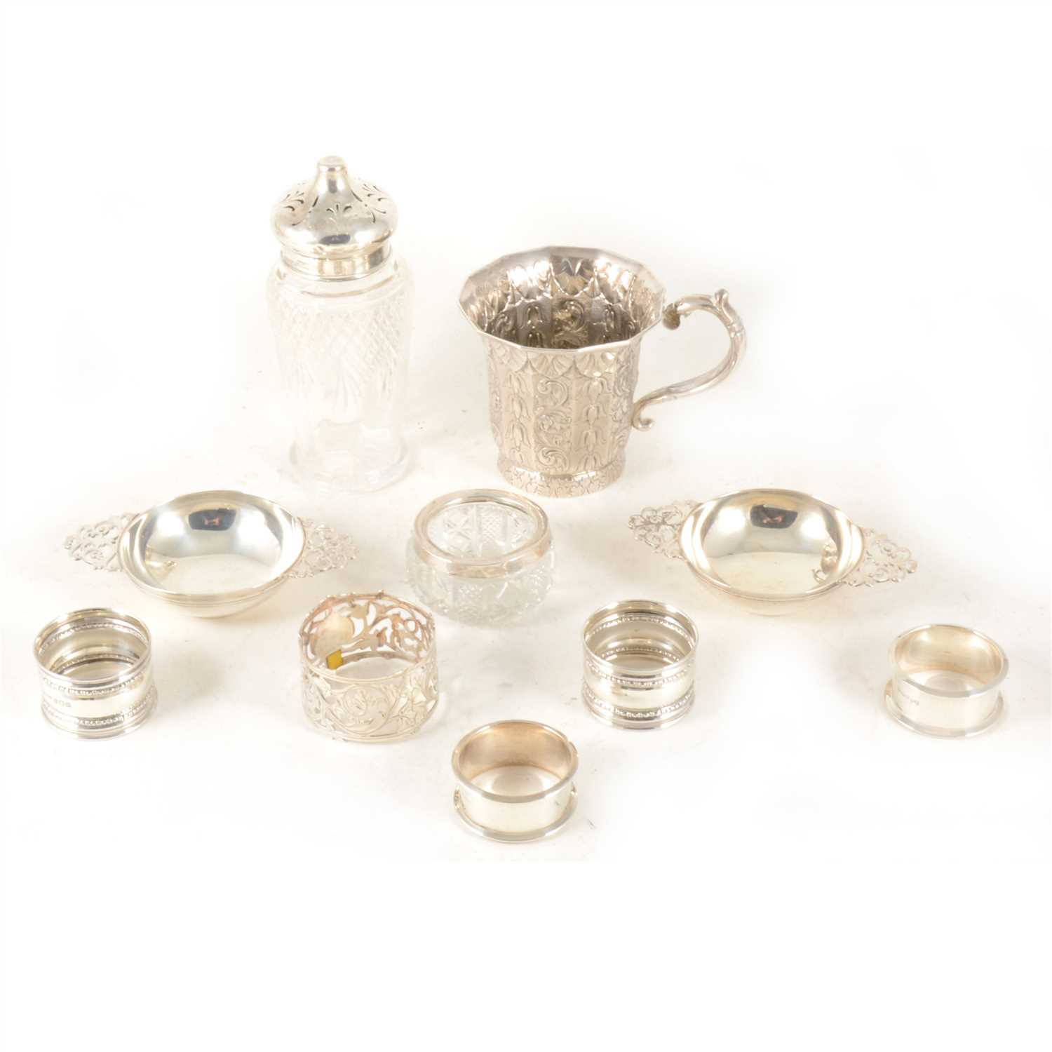 Lot 127 - A white metal mug, a pair of small silver quaiches and other small silver.