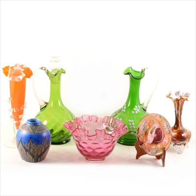 Lot 45 - A collection of decorative glass, cranberry, green glass decanter and jug, fluted trumpet vase with vaseline rim, Chameleon vase.