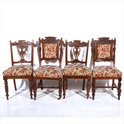 Lot 324 - Two sets of four Edwardian walnut dining chairs, upholstered en suite