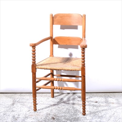 Lot 390 - An Arts & Crafts inspired beechwood elbow chair