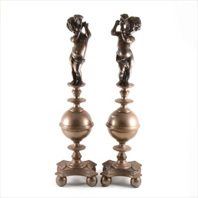 Lot 110 - A pair of early 20th Century French cast metal chenets, designed with cherub with cornucopia, 64cm.
