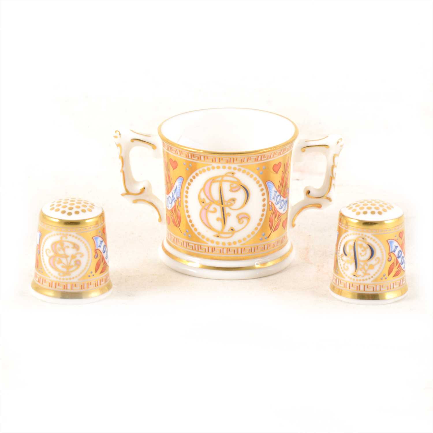 Lot 17 - Royal Crown Derby miniature loving cup and two thimbles.