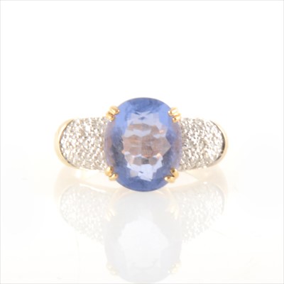 Lot 247 - An oval tanzanite and diamond ring.