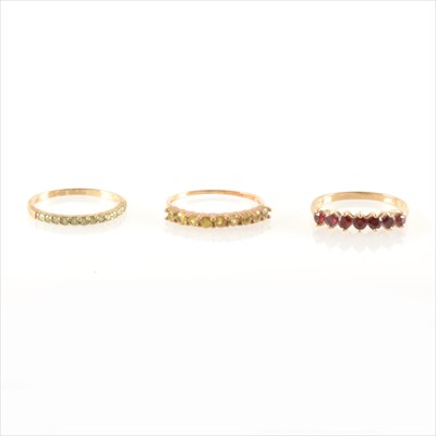 Lot 255 - Three coloured stone half eternity rings.