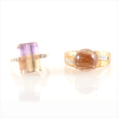 Lot 300 - A cabochon cut brown stone ring and an ametrine quartz ring.