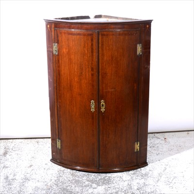 Lot 444 - George III oak bowfront corner cupboard