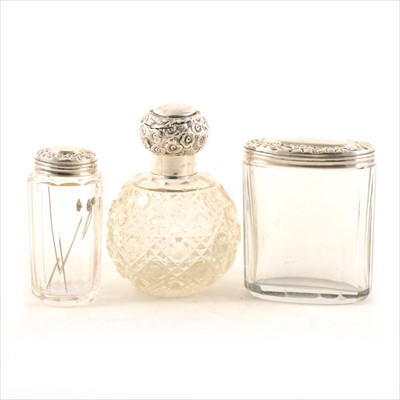 Lot 372 - A silver topped scent bottle and two silver-topped jars.