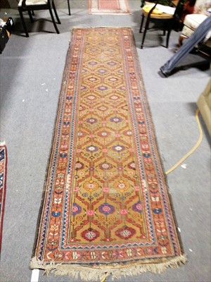 Lot 628 - A runner, sand coloured ground with pink and blue stylised floral field, ...