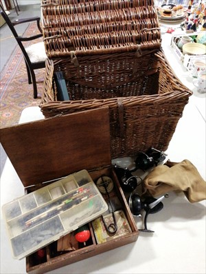 Lot 472 - Fishing equipment including three spinning reels, tackle, in a wicker creel.