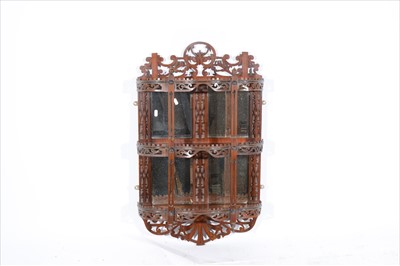 Lot 428 - A set of continental walnut and fret carved wall shelves