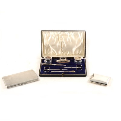 Lot 422 - Two silver cigarette cases and a silver manicure set.