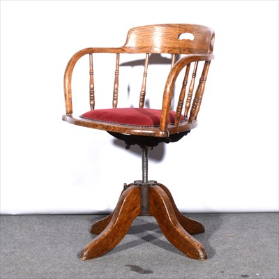 Lot 558 - An oak swivel office chair