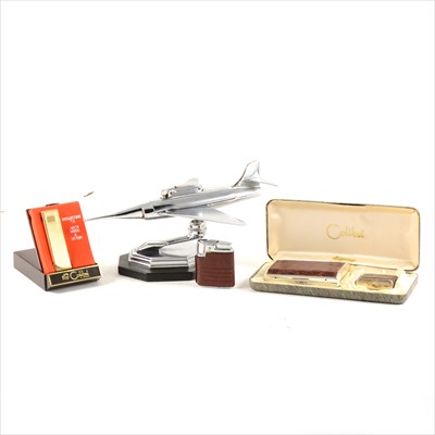 Lot 201 - A novelty chrome-plated jet fighter table lighter, 23cm, and other lighters.