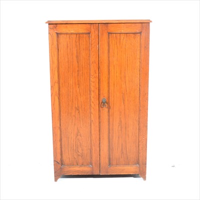 Lot 434 - An oak shoe cupboard, two panelled doors, width 57cm.