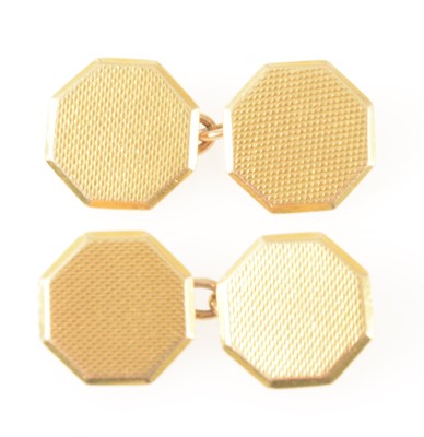Lot 136 - A pair of 18 carat yellow gold engine turned octagonal chain link cufflinks.