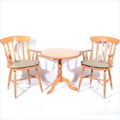 Lot 393 - A modern pine pedestal table, and pair of kitchen elbow chairs