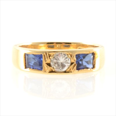 Lot 248 - A sapphire and diamond three stone ring.