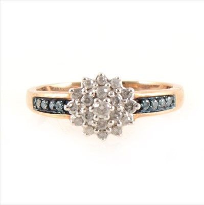 Lot 428 - A circular diamond cluster ring with blue diamond shoulders.