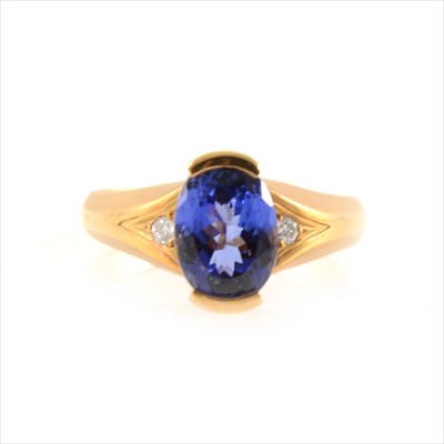 Lot 437 - A tanzanite solitaire ring with a diamond to each shoulder.