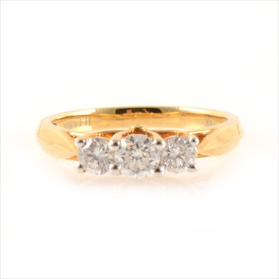 Lot 425 - A diamond three stone ring.