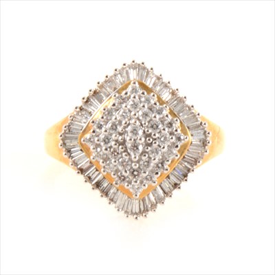 Lot 426 - A diamond cluster ring set with brilliant and baguette cut stones.