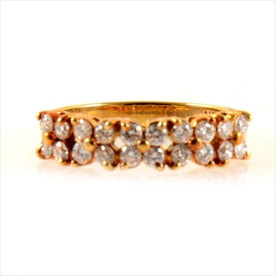 Lot 249 - A diamond two row eternity ring.