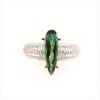 Lot 441 - A green tourmaline and diamond dress ring.