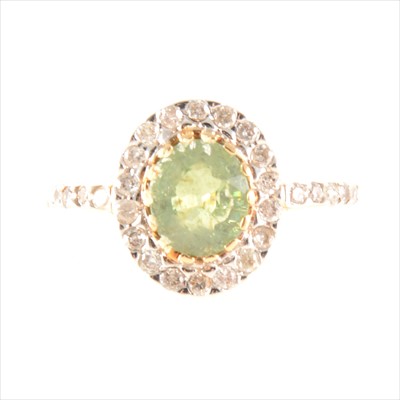 Lot 198A - A green stone and diamond oval cluster ring.