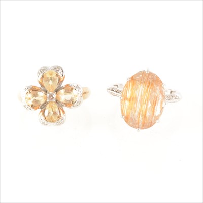 Lot 193 - A yellow stone floral design ring and a rutilated quartz ring.