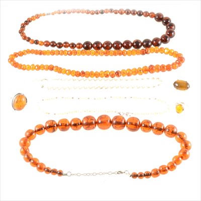 Lot 328 - Three amber coloured bead necklaces, two amber rings, costume jewellery brooch, cultured pearl necklace and small pearl two row necklace.