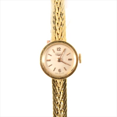 Lot 338 - Longines - a lady's 18 carat yellow gold bracelet watch.