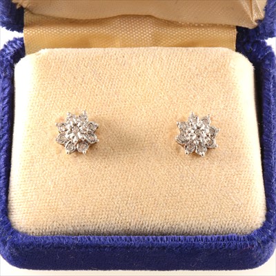 Lot 264 - A pair of diamond cluster earrings.