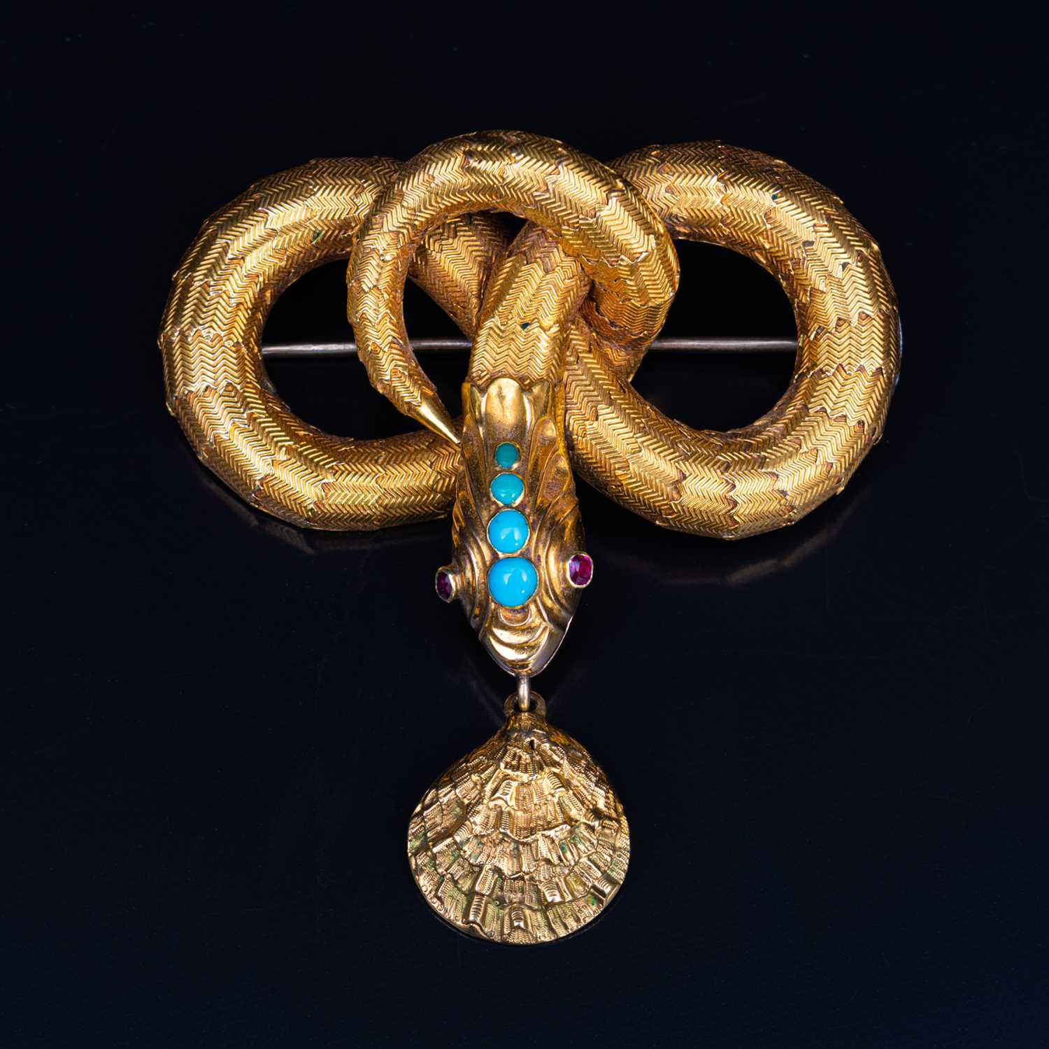68 - A mid 19th Century yellow metal brooch, in the form of a coiled snake with simulated scales,