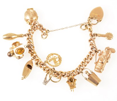 Lot 98 - A rose metal hollow curb link bracelet with ten charms attached.