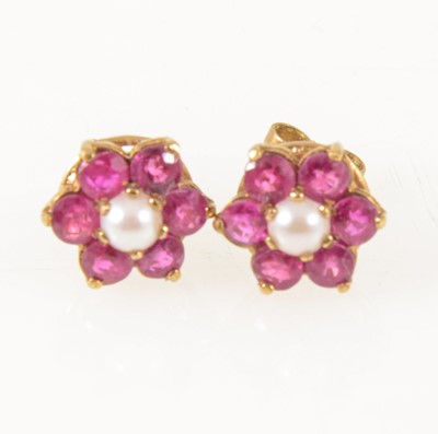 Lot 1231 - A pair of ruby and pearl cluster ear studs