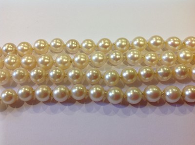 Lot 126 - A two row cultured pearl necklace with amethyst fastener.