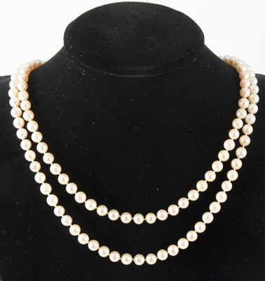 Lot 127 - A two row cultured pearl necklace with garnet clasp.