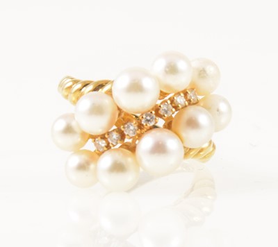 Lot 35 - Mikimoto -  an 18 carat yellow gold dress ring set with seven graduated small diamond and pearls.