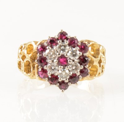 Lot 27 - A vintage ruby and diamond circular cluster ring.