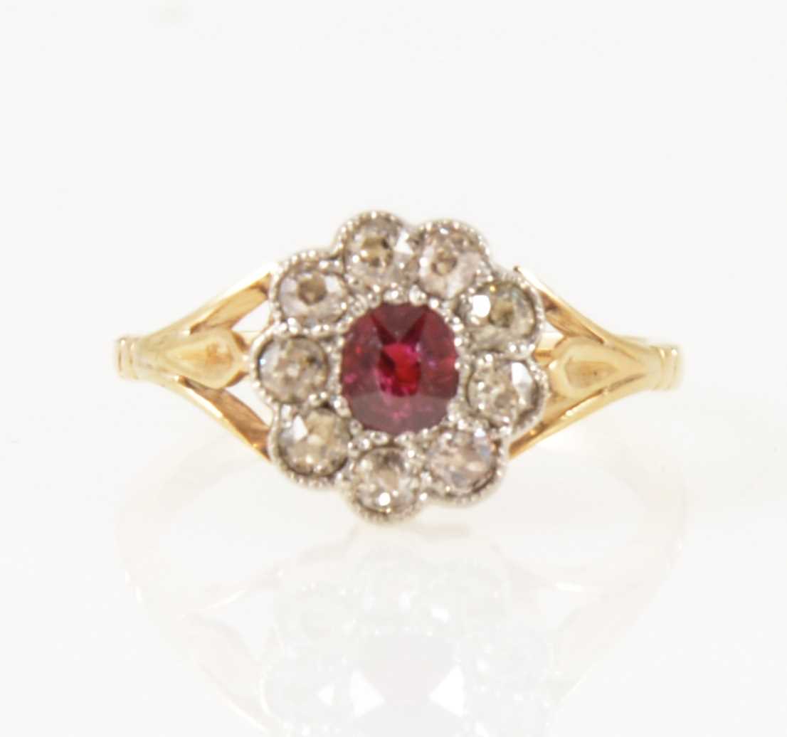 Lot 25 - A ruby and diamond cluster ring.