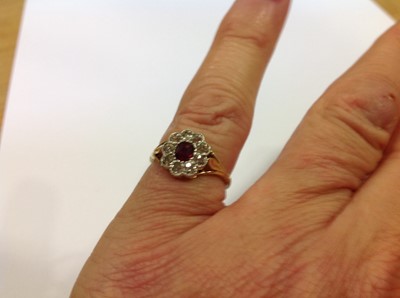 Lot 25 - A ruby and diamond cluster ring.