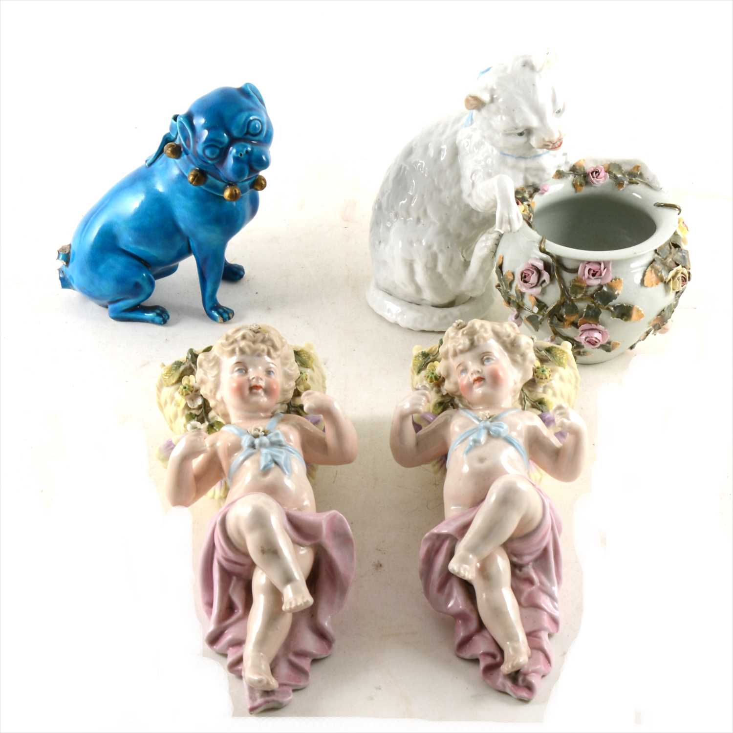 Lot 10 - A pair of Continental porcelain wall pockets, modelled with cherubs; a modelled cat posy bowl...