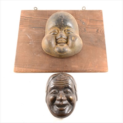 Lot 192 - A Japanese cast metal mask, and another fixed to a pine board.