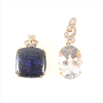 Lot 215 - A rutilated quartz pendant and an opaque iridescent stone pendant.