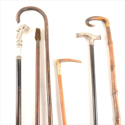 Lot 129 - A Victorian hunting crop, silver mounted, and other walking sticks