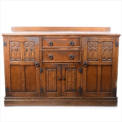 Lot 256 - A reproduction oak sideboard, with panelled Gothic tracery and linen folds