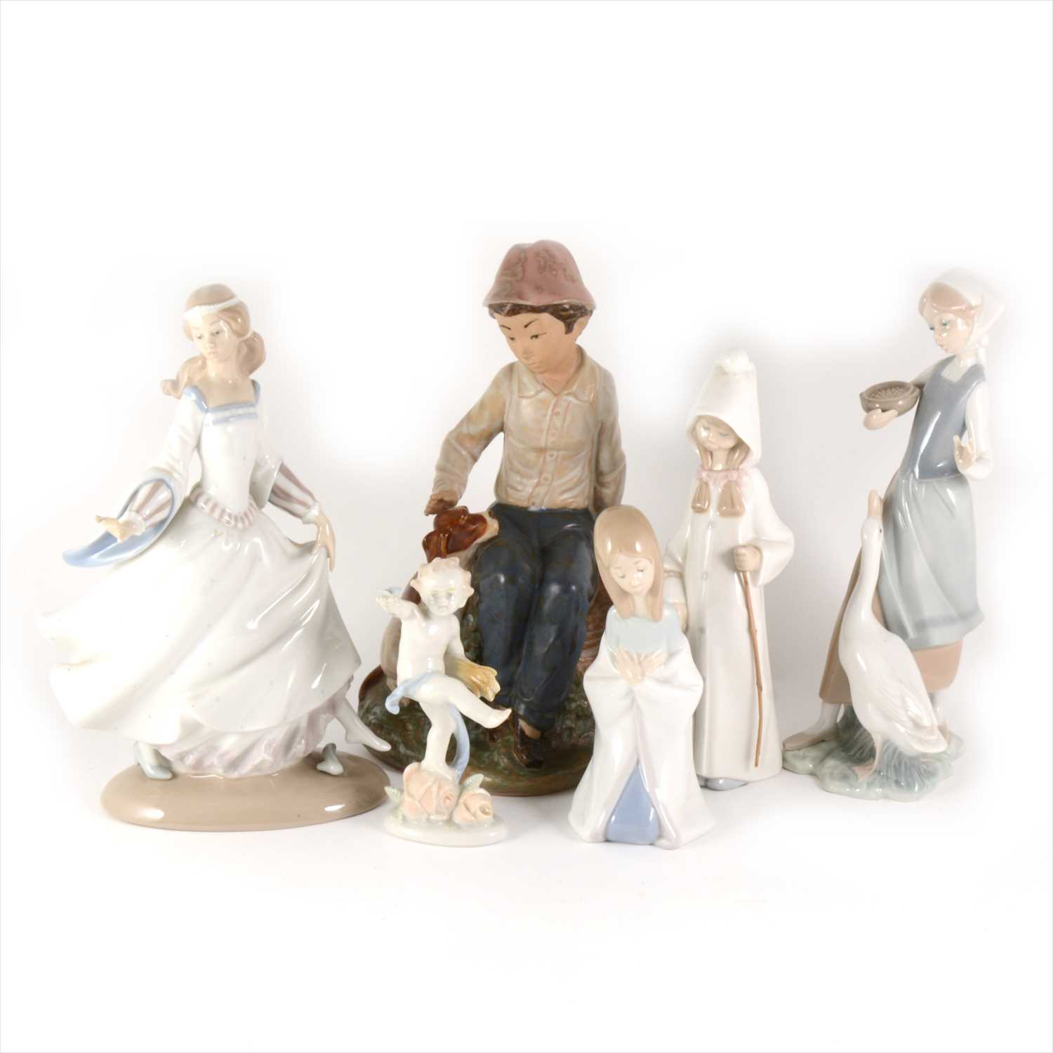 Lot 5 - Four Lladro figures, one Nao figures, and a German figure.