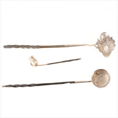 Lot 158 - Two repoussé chased toddy ladles with whalebone handles, plus a small cream toddy ladle.